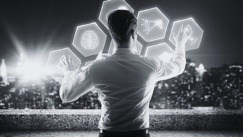 The Future of Leadership Why 2026 Belongs to AI Driven Teams - Black and white photo of a man rearranging digital tiles representing learning and leadership and other business aspects